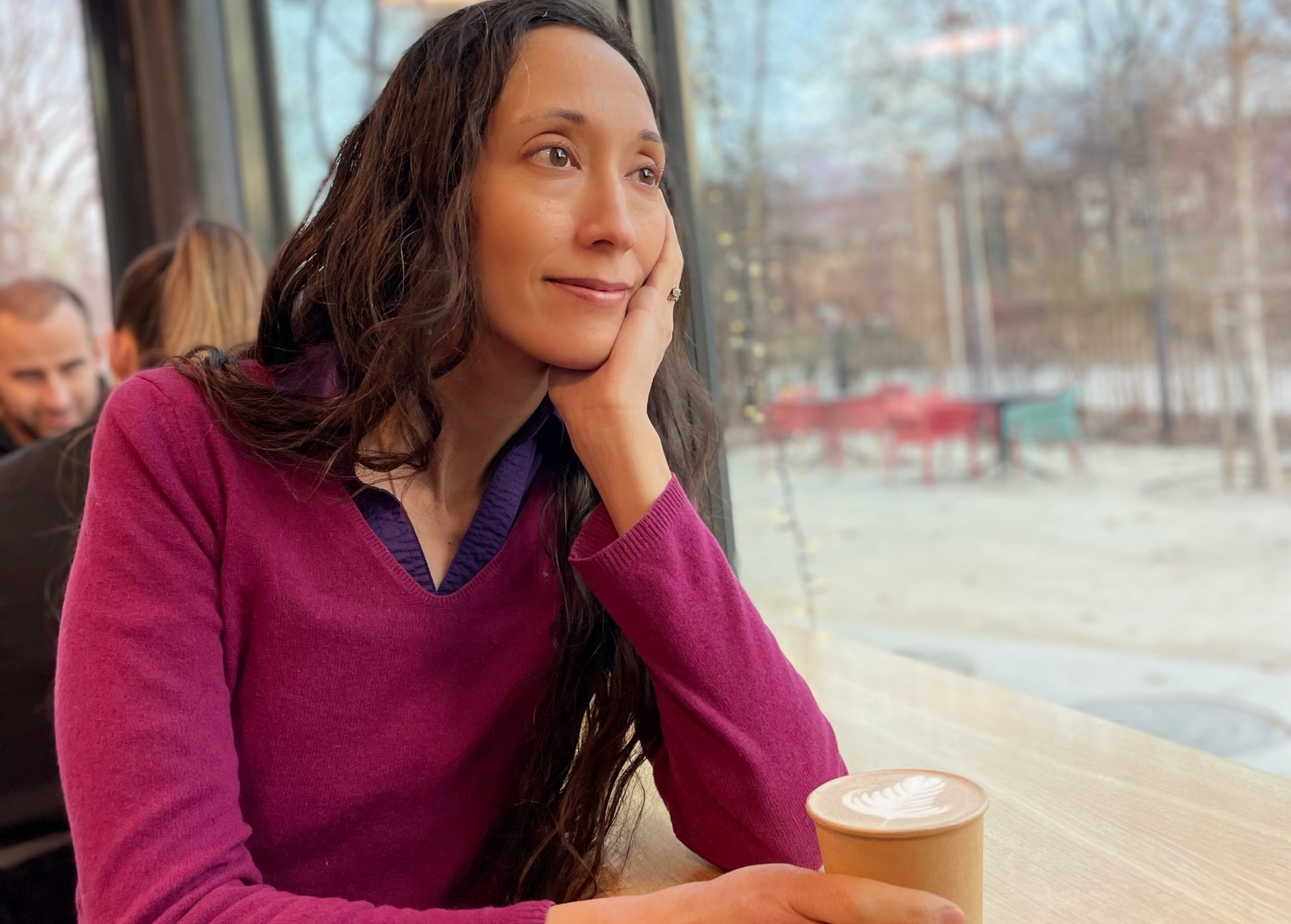 Photo of Sharon with a latte and a thoughtful expression
